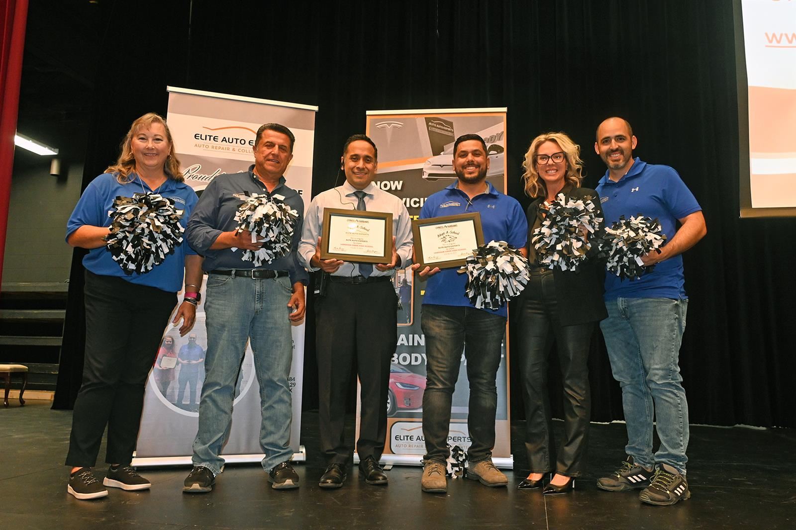 Representatives from Elite Auto Experts join Langham Creek High School and CFISD personnel for a photo.